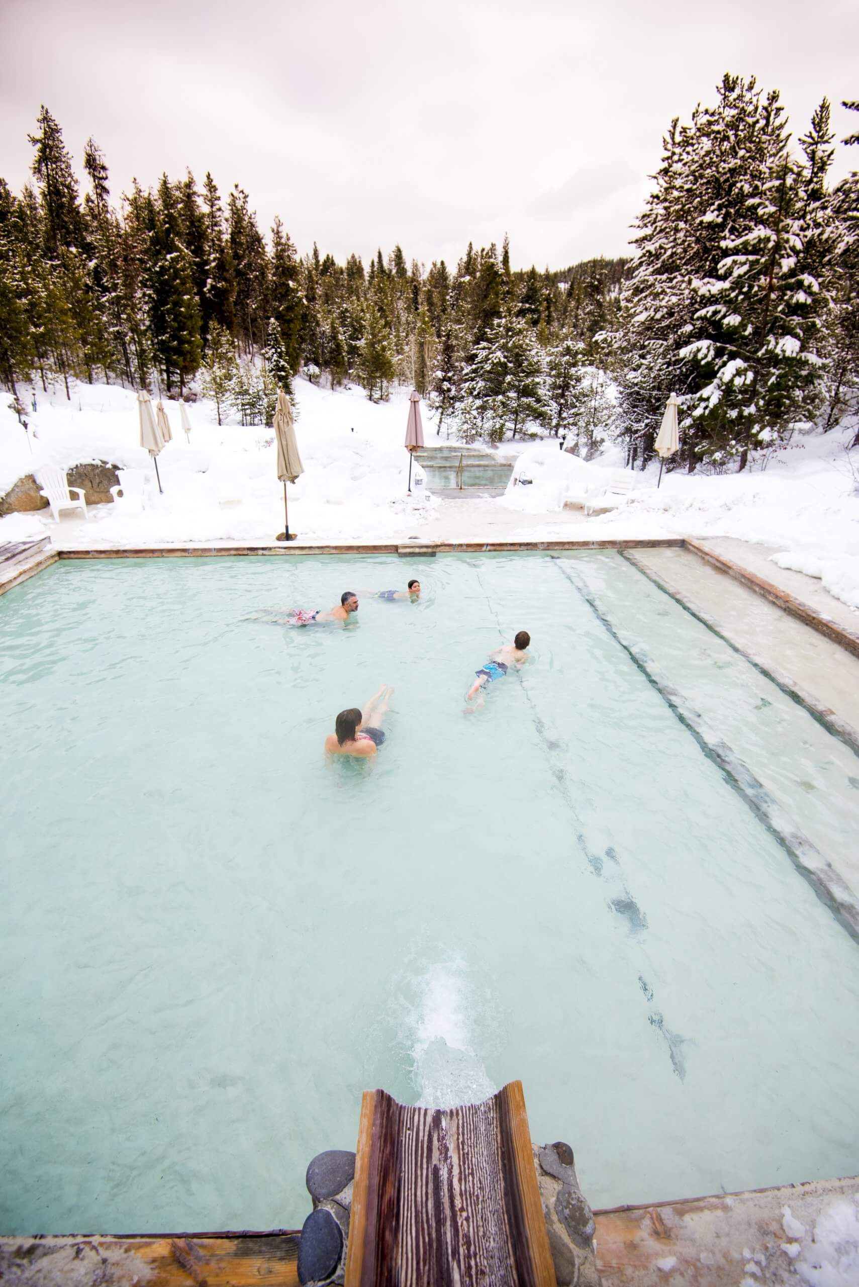 A family enjoying Gold Fork Hot Springs during the winter.
