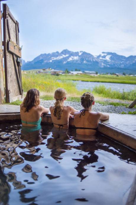people in hot tub looking at mountains