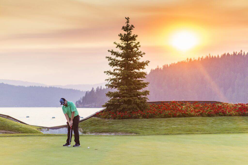 A man golfing at sunset at Coeur d'Alene Golf Resort.