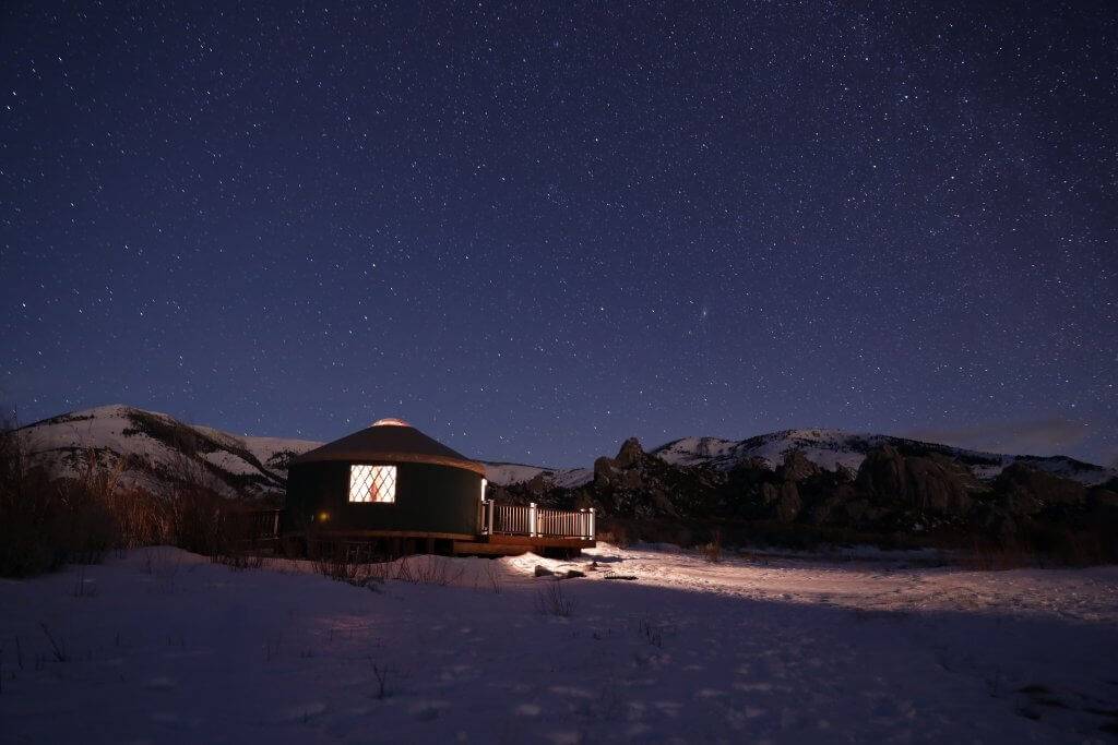 exterior of yurt at night with night sky