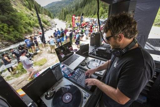 dj with a crowd along the river