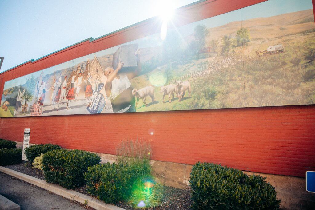 View of the Basque Mural, depicting sheep, an accordian player, dancers and other images.