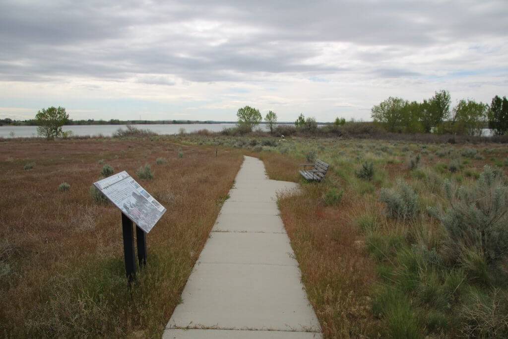 the concrete trail leads through the sagebrush with interpretive signs and benches along the way