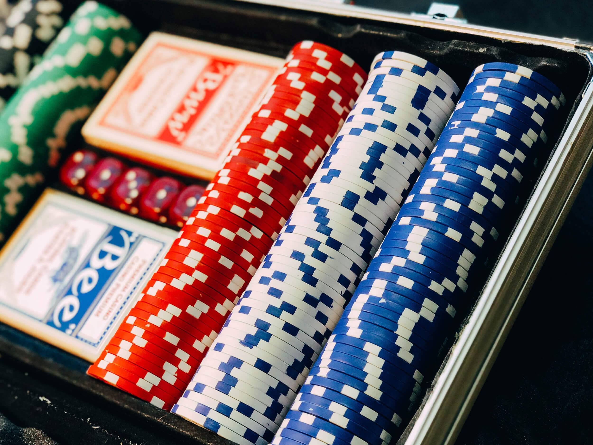 View of casino chips, dice and playing cards.