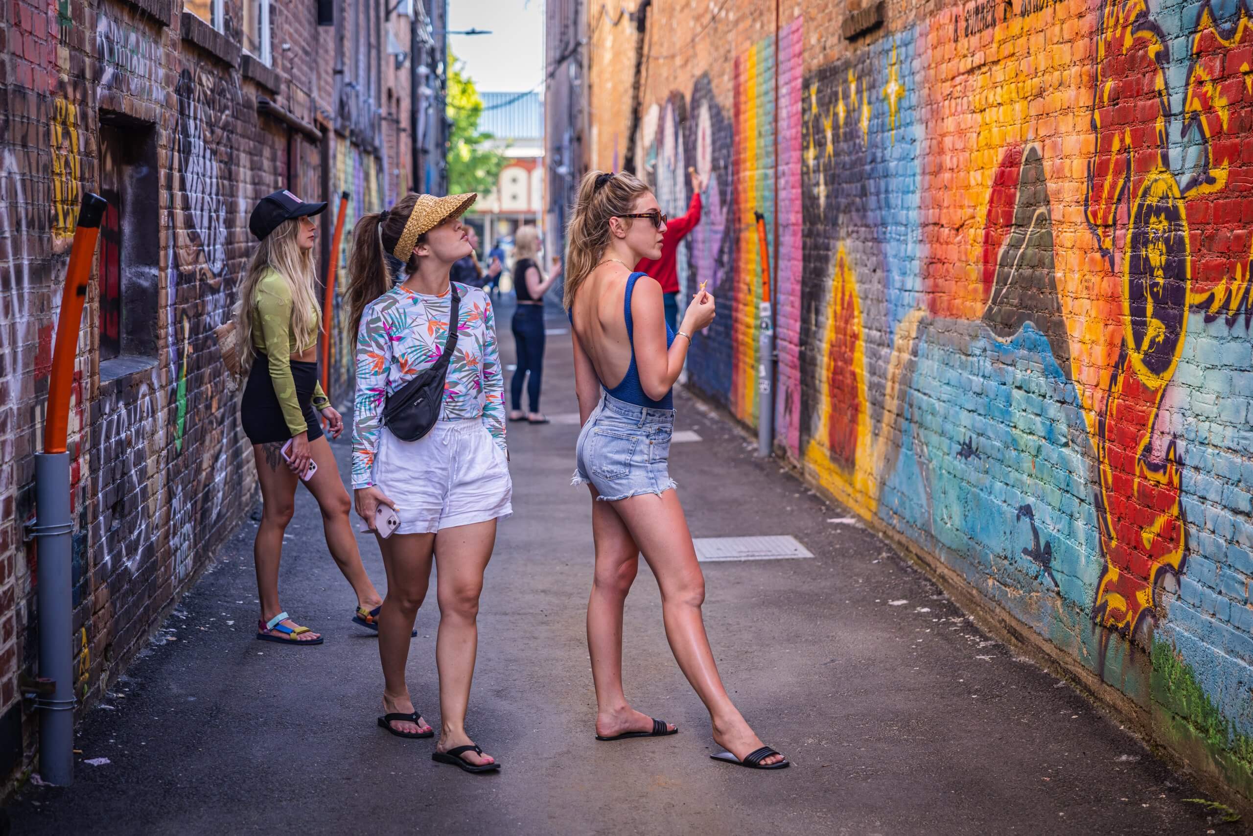 Three women look at graffiti art in Graffiti Alley in Sandpoint.