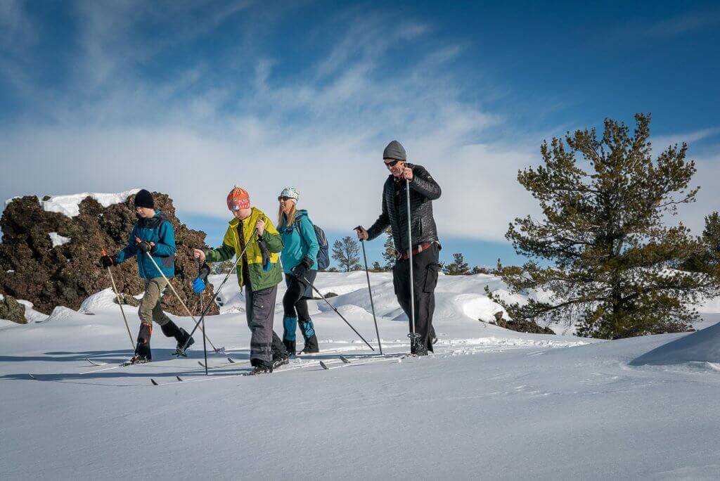 A family cross-country skiing together at Craters of the Moon National Monument and Preserve.