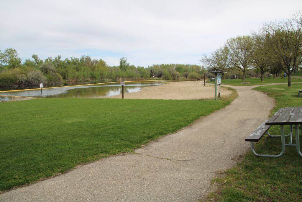 The paved trail along the lake, with the swimming beach on the left.