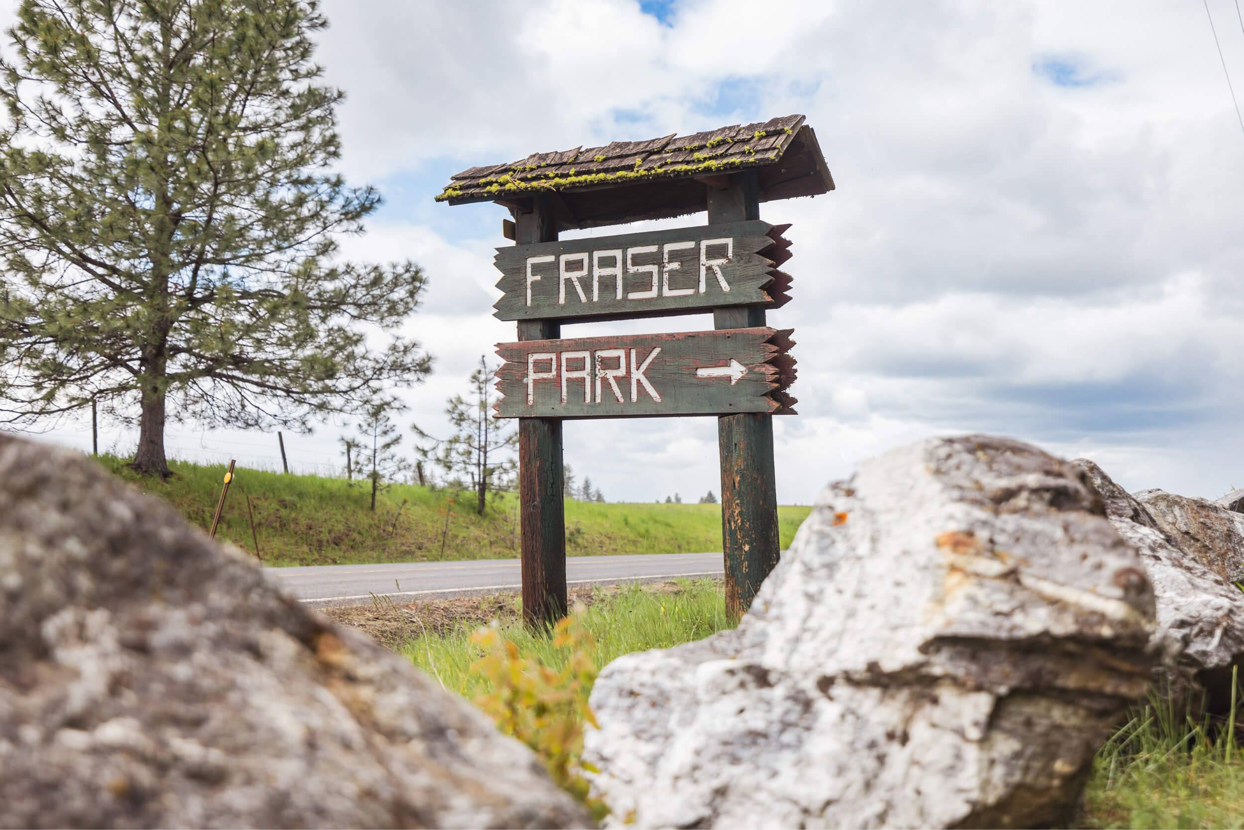 A wooden sign that reads Fraser Park.