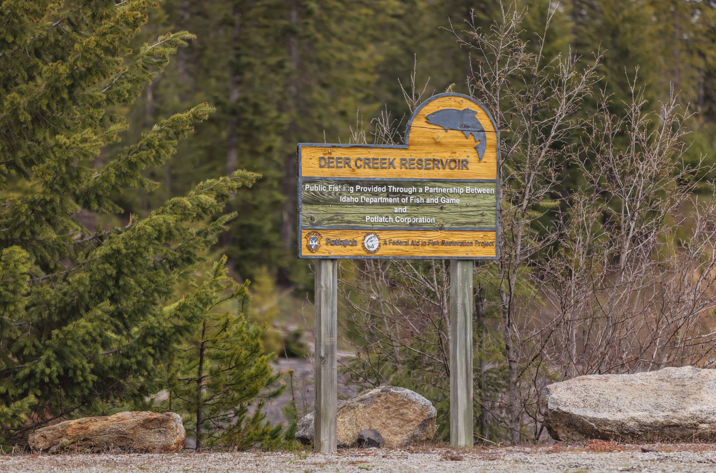 A painted wooden sign for Deer Creek Reservoir.