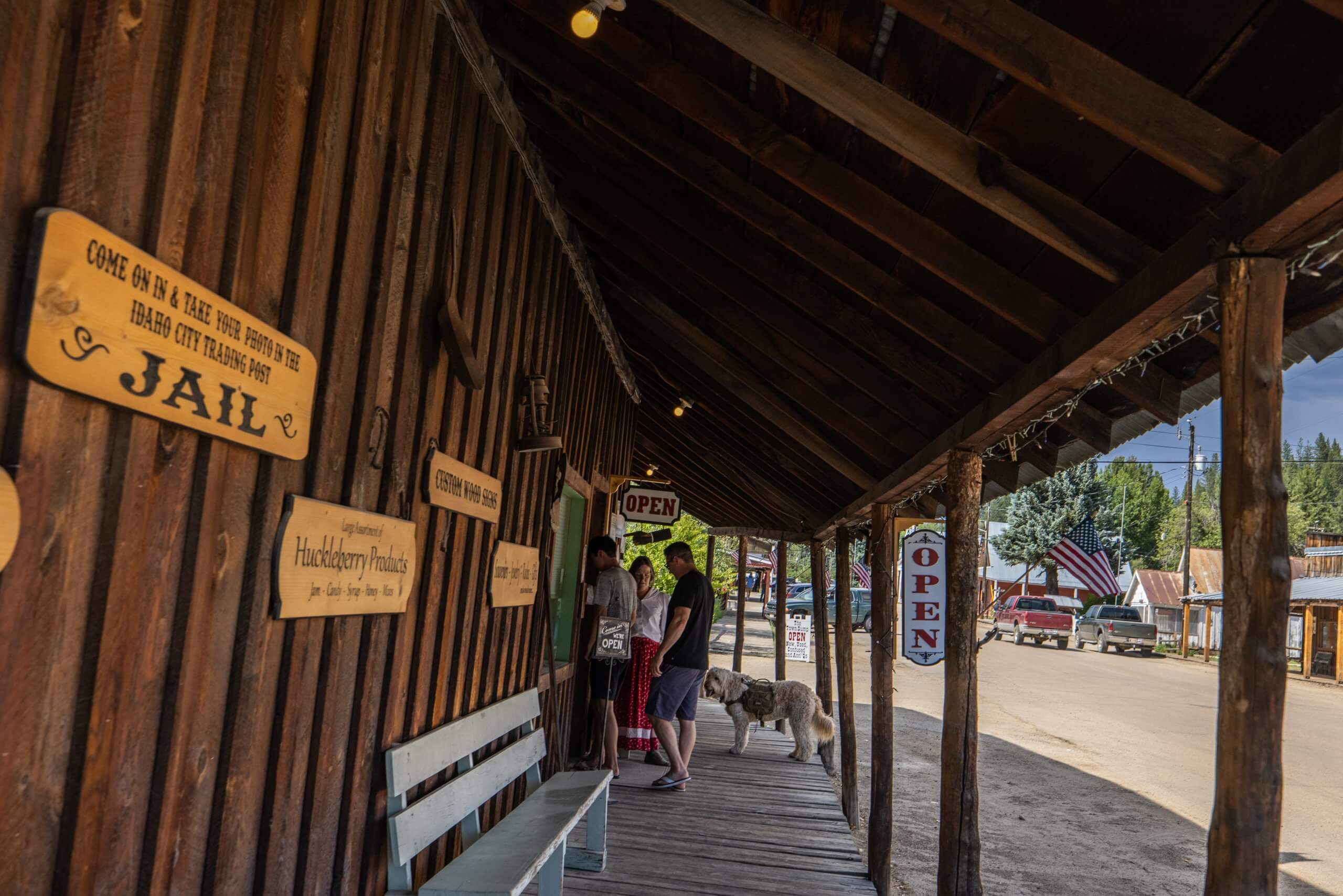 a group of people standing in front of a wooden, historical building in Idaho City