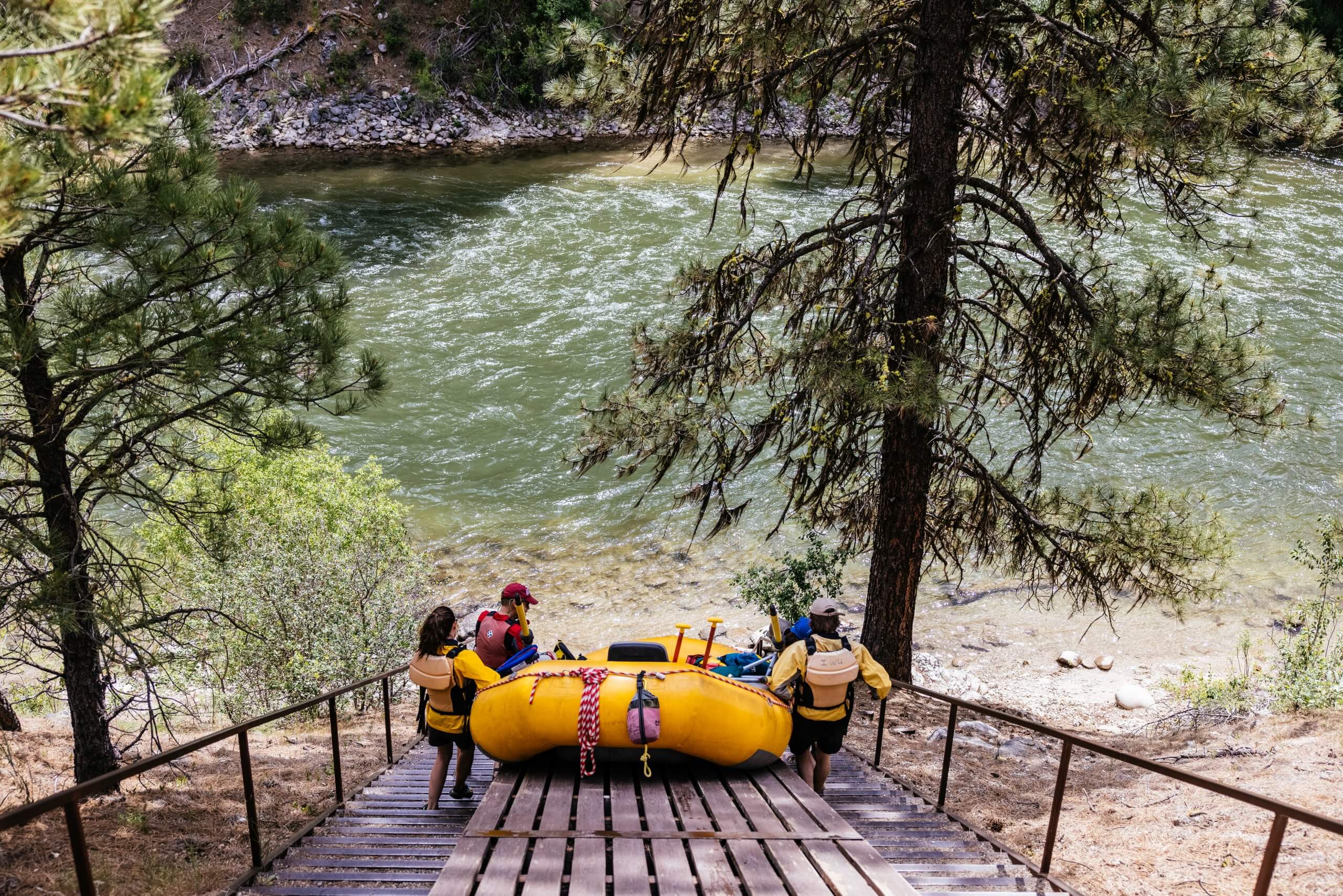 Group of people launching a rafting boat at Swirly Canyon