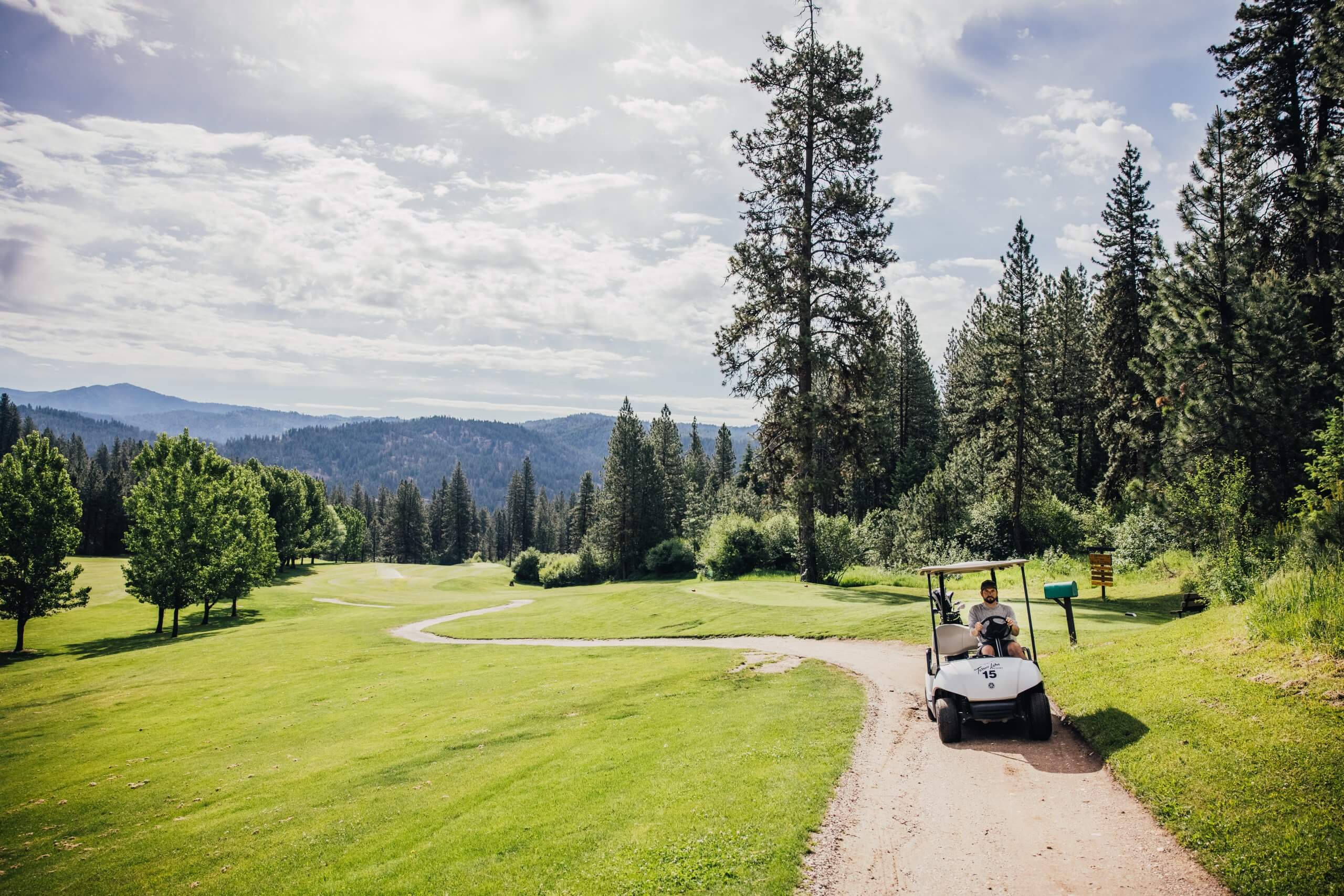 Man riding a golf cart at Terrace Lakes Resort in Garden Valley