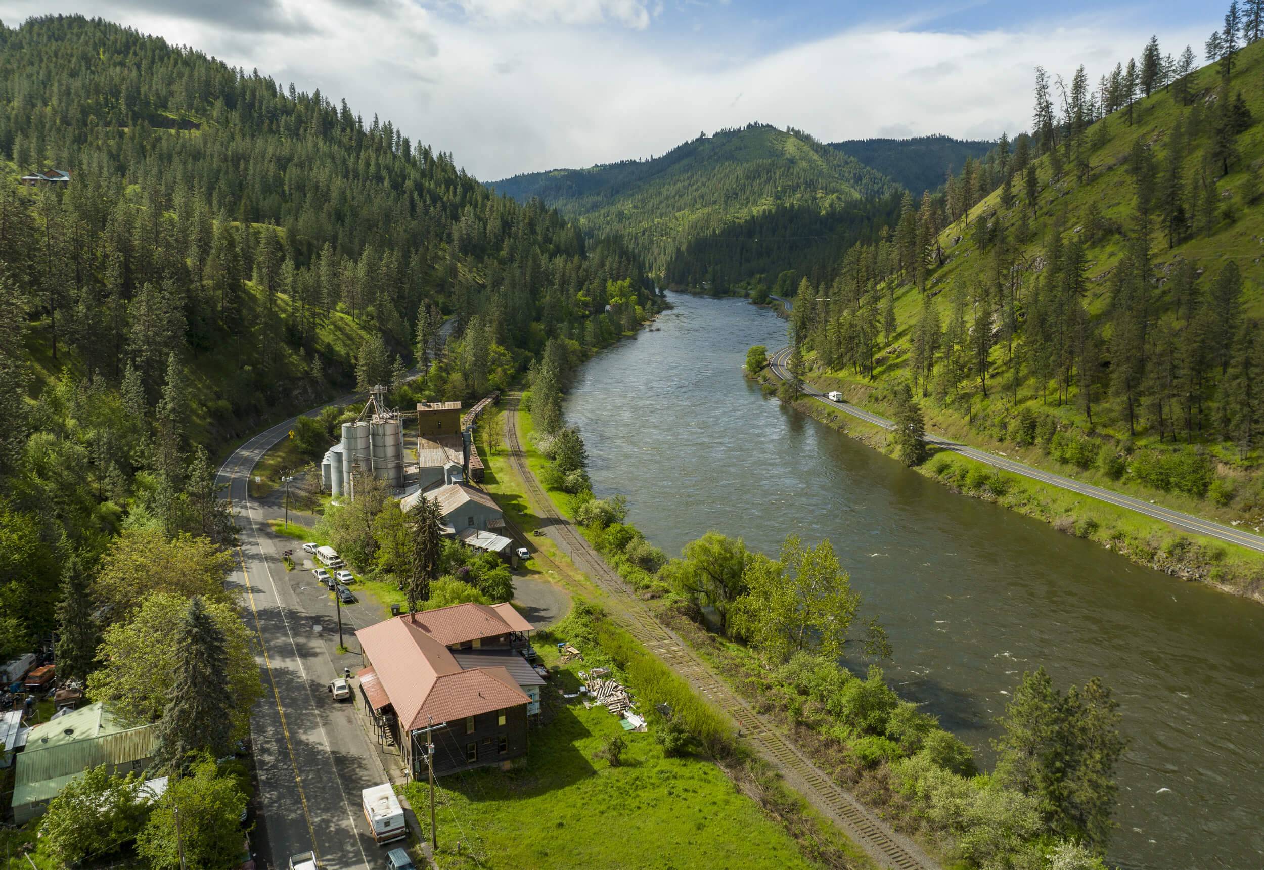 An aerial view of the Clearwater River winding through tree-covered mountains