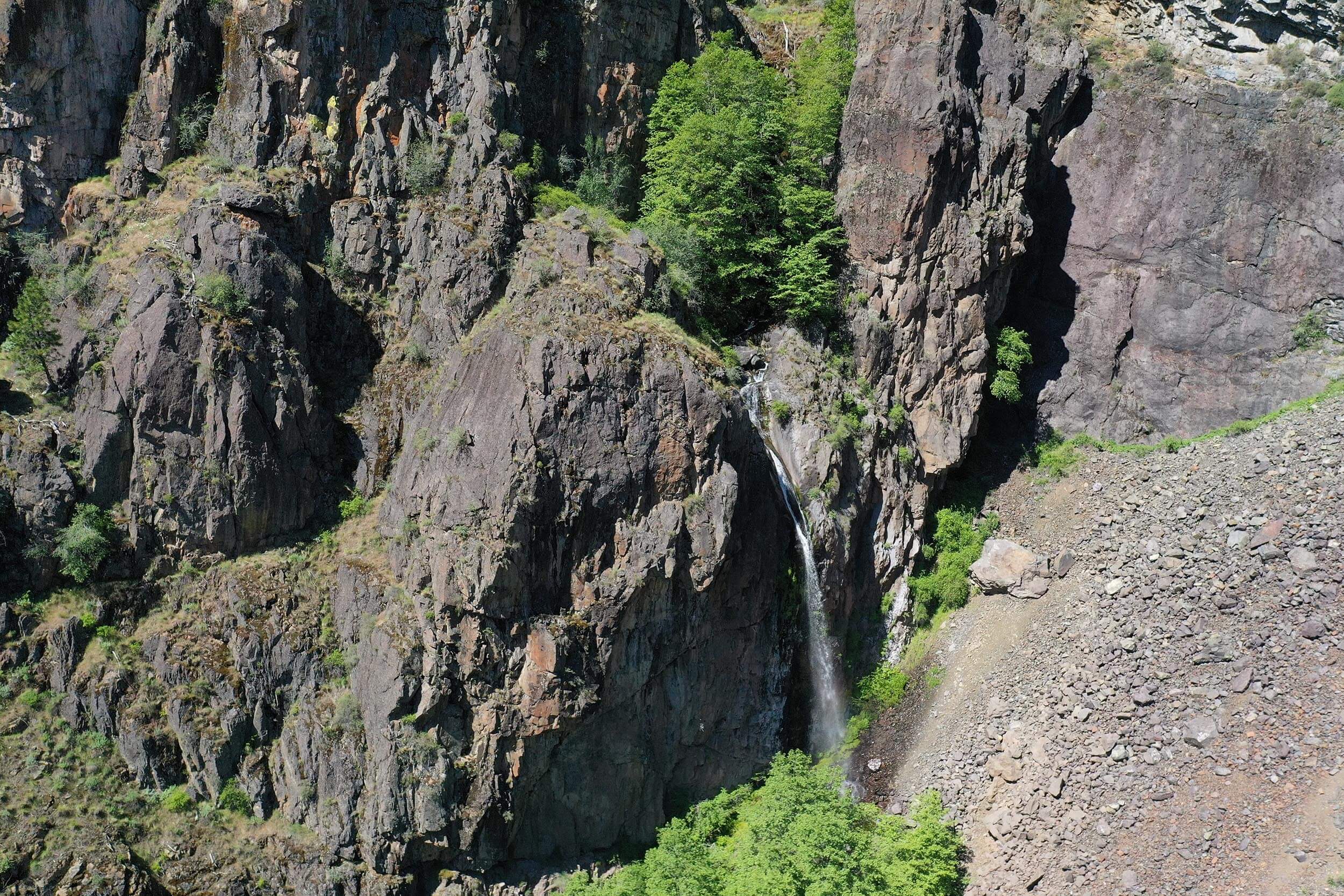 overhead view of jagged rock formations and a waterfall