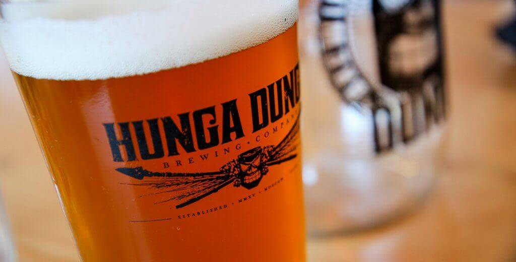 brew filling a Hunga Dunga Brewing Co. logoed pint glass.