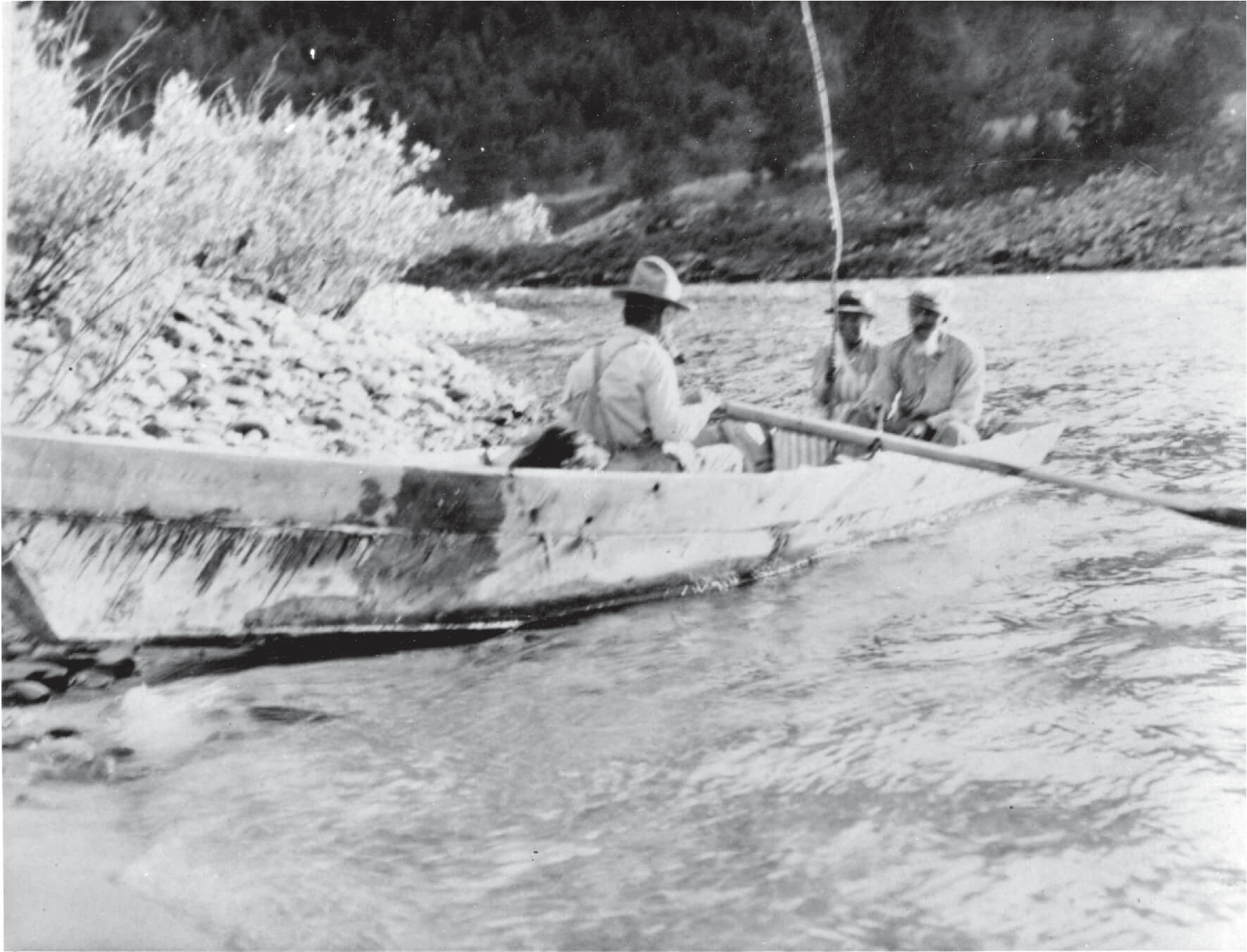A black-and-white photo of Polly and Charlie Bemis setting out in a boat on the Salmon River with a third man paddling.