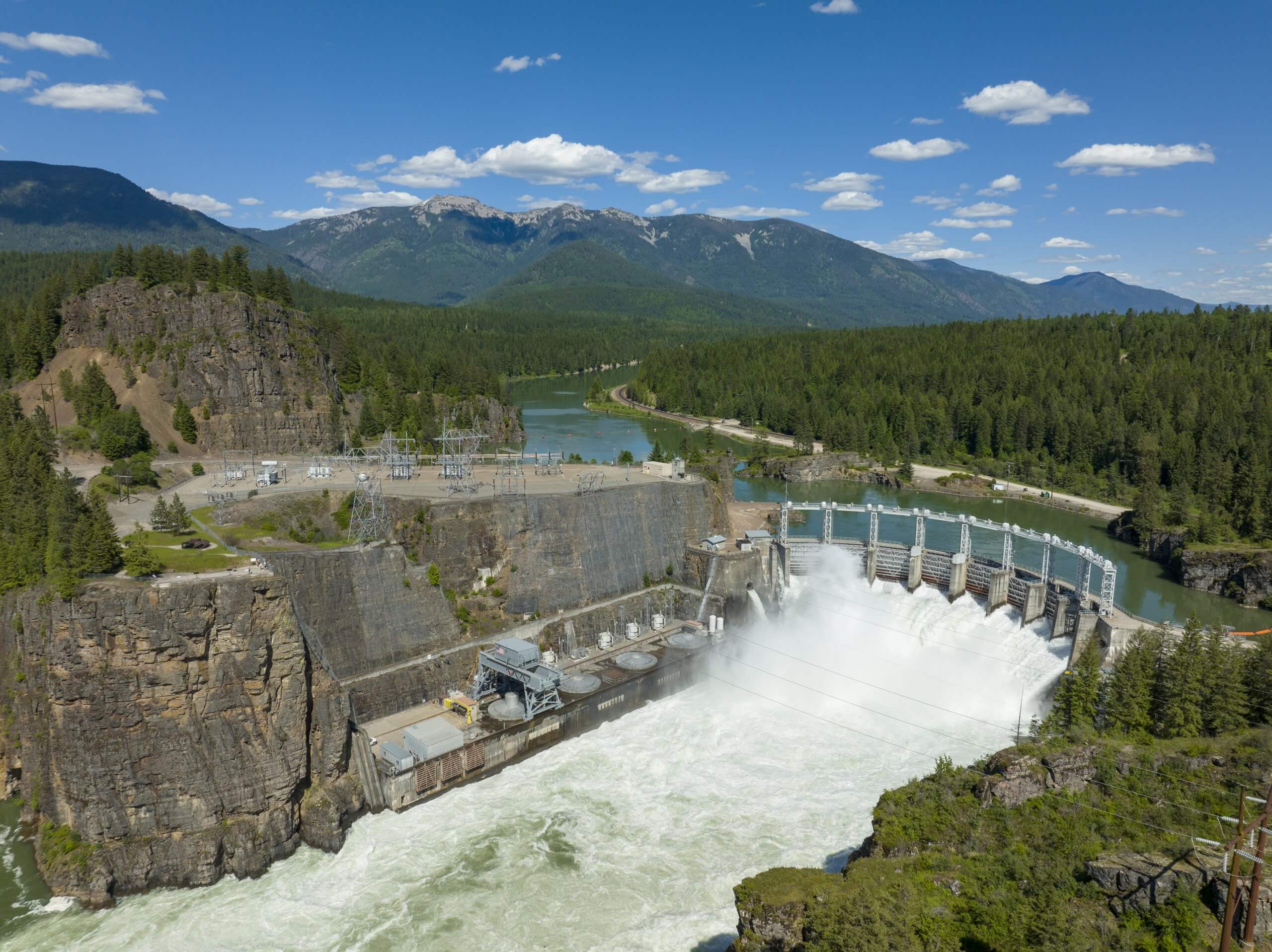 Aerial view of water rushing through a dam.