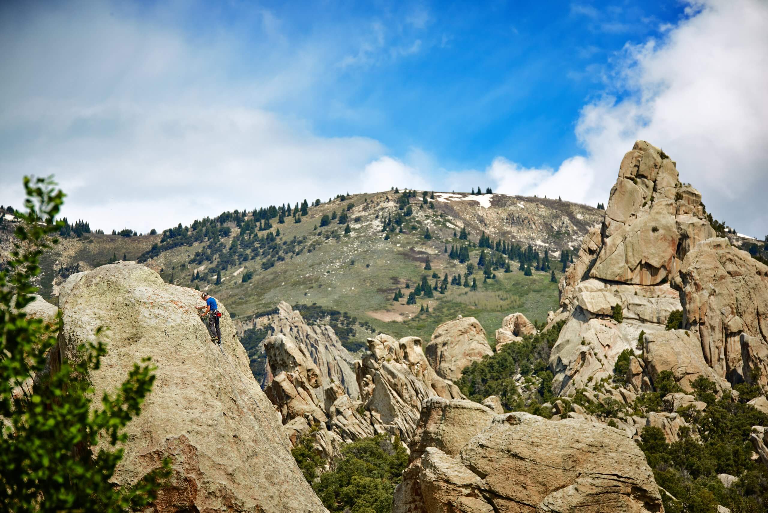 A person climbing one of the many towering rock formations at Castle Rocks State Park.