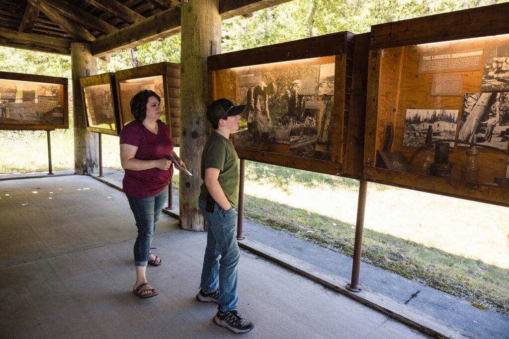 A mother and son look at exhibits at the Marble Creek Historical Park.