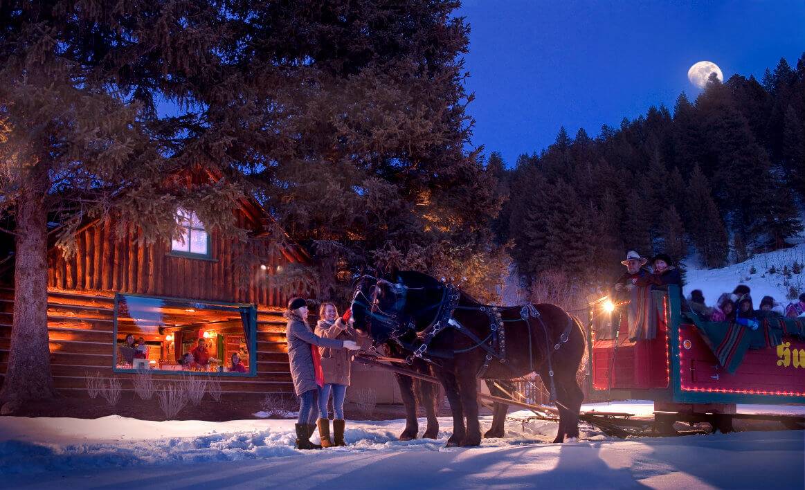 People preparing for a night time sleigh ride in Sun Valley.