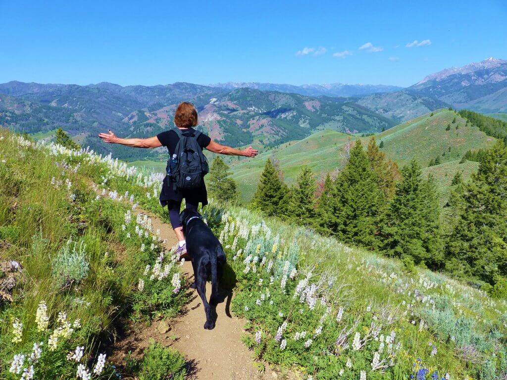 Woman hiking with dog.