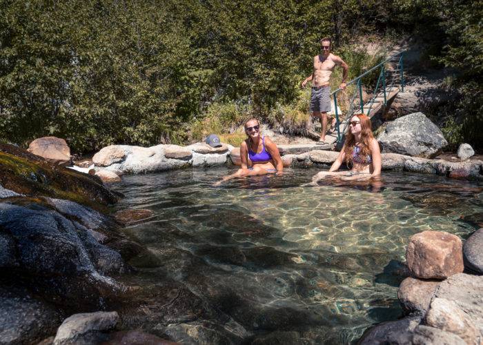 3 people in a natural hot pool