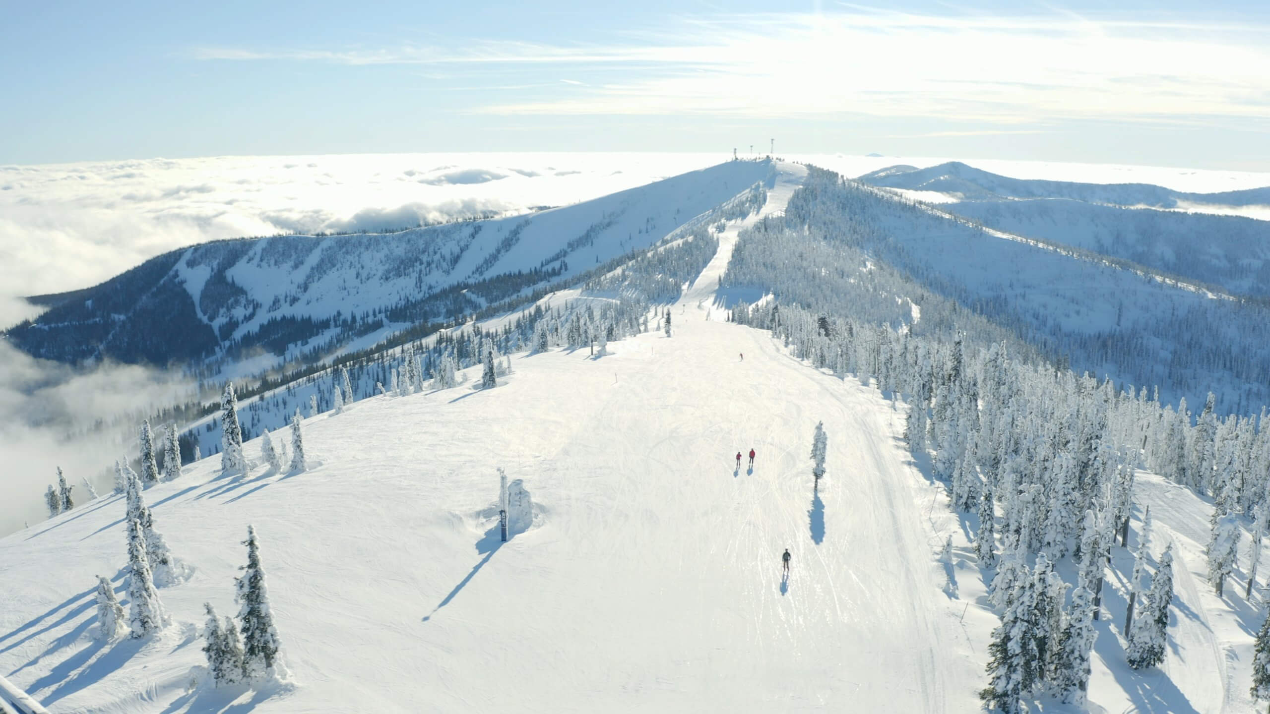 Aerial view of people skiing down a snowy mountain.
