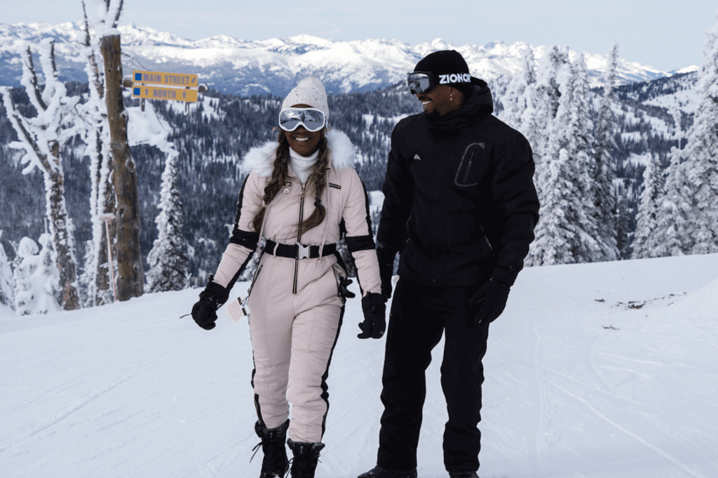 Two people in snow and ski gear standing at the top of the Main Street and North ski run at Brundage Mountain Resort.